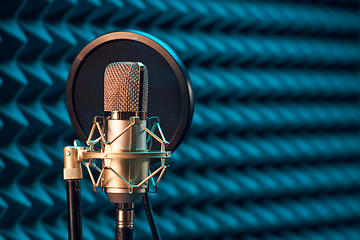 Image showing Studio chrome microphone on acoustic foam panel background,