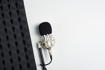 Image showing Flat lay of microphone and acoustic foam panel, over white background