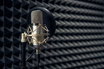 Image showing Studio chrome microphone on acoustic foam panel background, shallow depth of field