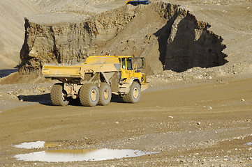 Image showing Yellow dump truck working in gravel pit