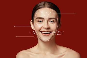 Image showing Beautiful female face with lifting up arrows isolated on red background