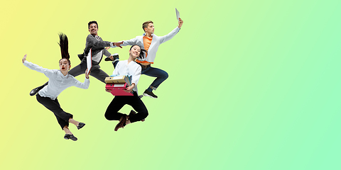 Image showing Happy office workers jumping and dancing in casual clothes or suit on gradient neon fluid background. Flyer with copyspace