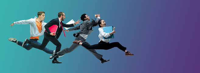 Image showing Happy office workers jumping and dancing in casual clothes or suit on gradient neon fluid background. Flyer with copyspace