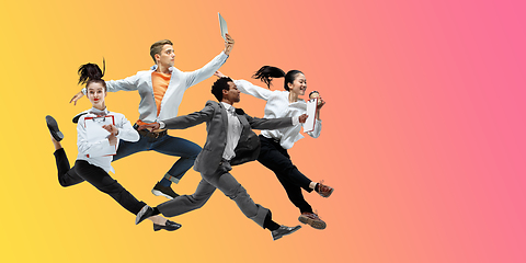 Image showing Happy office workers jumping and dancing in casual clothes or suit on gradient neon fluid background. Flyer with copyspace