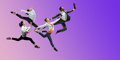 Image showing Happy office workers jumping and dancing in casual clothes or suit on gradient neon fluid background. Flyer with copyspace