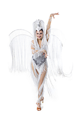 Image showing Beautiful young woman in carnival, stylish masquerade costume with feathers dancing on white studio background. Concept of holidays celebration, festive time, fashion