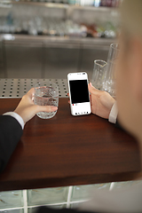 Image showing Close up hands holding smartphone with social media on the screen. Staying safe during lockdown. Modern tech and healthcare, copyspace