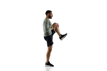 Image showing Young caucasian male model in action, motion isolated on white background. Concept of sport, movement, energy and dynamic, healthy lifestyle. Training, practicing.