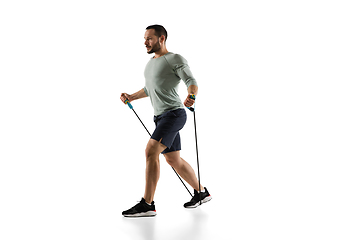 Image showing Young caucasian male model in action, motion isolated on white background. Concept of sport, movement, energy and dynamic, healthy lifestyle. Training, practicing.