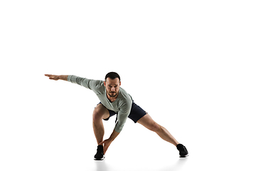 Image showing Young caucasian male model in action, motion isolated on white background. Concept of sport, movement, energy and dynamic, healthy lifestyle. Training, practicing.