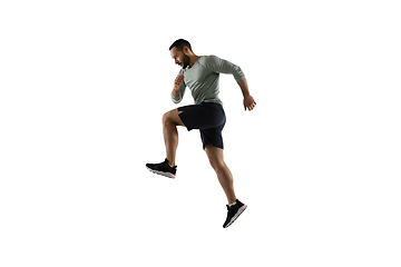 Image showing Young caucasian male model in action, motion isolated on white background. Concept of sport, movement, energy and dynamic, healthy lifestyle. Training, practicing.