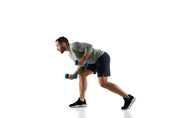 Image showing Young caucasian male model in action, motion isolated on white background. Concept of sport, movement, energy and dynamic, healthy lifestyle. Training, practicing.