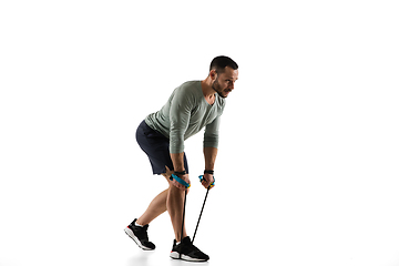 Image showing Young caucasian male model in action, motion isolated on white background. Concept of sport, movement, energy and dynamic, healthy lifestyle. Training, practicing.