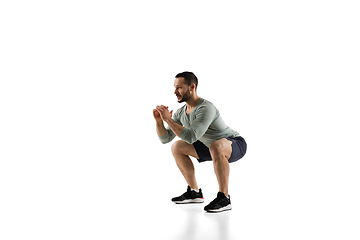 Image showing Young caucasian male model in action, motion isolated on white background. Concept of sport, movement, energy and dynamic, healthy lifestyle. Training, practicing.