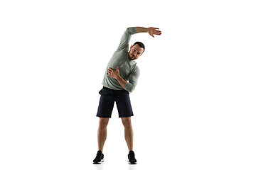 Image showing Young caucasian male model in action, motion isolated on white background. Concept of sport, movement, energy and dynamic, healthy lifestyle. Training, practicing.