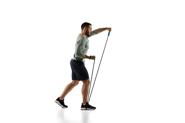 Image showing Young caucasian male model in action, motion isolated on white background. Concept of sport, movement, energy and dynamic, healthy lifestyle. Training, practicing.