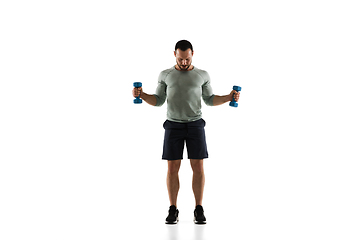 Image showing Young caucasian male model in action, motion isolated on white background. Concept of sport, movement, energy and dynamic, healthy lifestyle. Training, practicing.