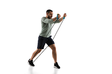 Image showing Young caucasian male model in action, motion isolated on white background. Concept of sport, movement, energy and dynamic, healthy lifestyle. Training, practicing.