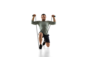 Image showing Young caucasian male model in action, motion isolated on white background. Concept of sport, movement, energy and dynamic, healthy lifestyle. Training, practicing.