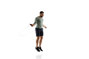 Image showing Young caucasian male model in action, motion isolated on white background. Concept of sport, movement, energy and dynamic, healthy lifestyle. Training, practicing.