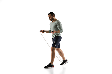 Image showing Young caucasian male model in action, motion isolated on white background. Concept of sport, movement, energy and dynamic, healthy lifestyle. Training, practicing.