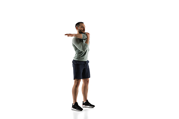 Image showing Young caucasian male model in action, motion isolated on white background. Concept of sport, movement, energy and dynamic, healthy lifestyle. Training, practicing.