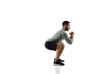 Image showing Young caucasian male model in action, motion isolated on white background. Concept of sport, movement, energy and dynamic, healthy lifestyle. Training, practicing.