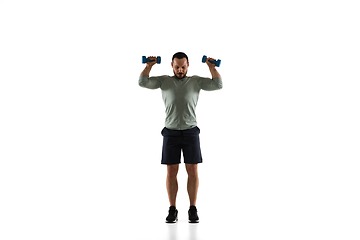 Image showing Young caucasian male model in action, motion isolated on white background. Concept of sport, movement, energy and dynamic, healthy lifestyle. Training, practicing.