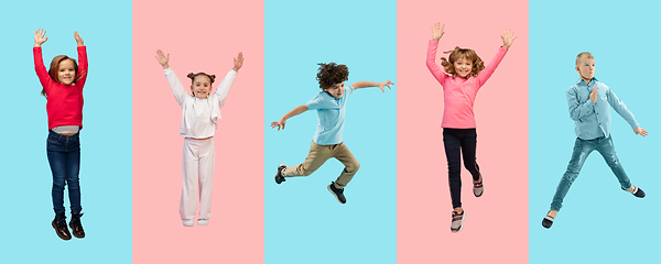 Image showing Group of elementary school kids or pupils jumping in colorful casual clothes on bicolored studio background. Creative collage.