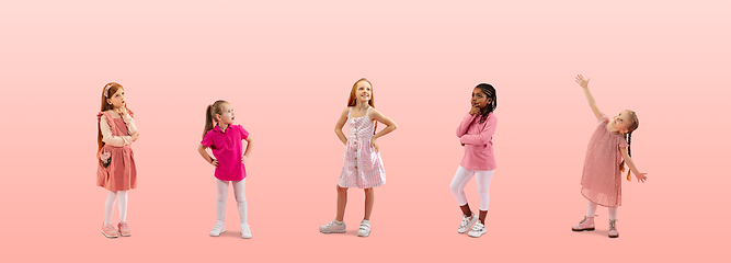 Image showing Group of elementary school kids or pupils dreaming in colorful casual clothes on pink studio background. Creative collage.