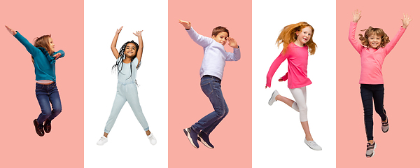 Image showing Group of elementary school kids or pupils jumping in colorful casual clothes on bicolored studio background. Creative collage.