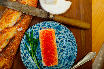 Image showing French cheese and fresh  baguette on a wood cutter