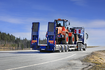 Image showing White Semi Truck Transports Wheel Loader