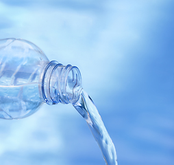 Image showing Blue bottle pouring water