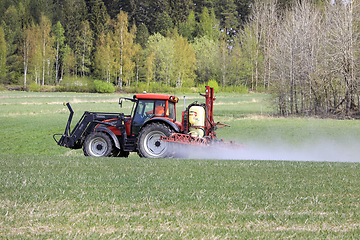 Image showing Tractor and Sprayer in Field in the Spring