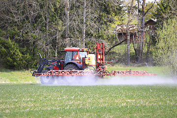 Image showing Tractor and Sprayer in Field in the Spring