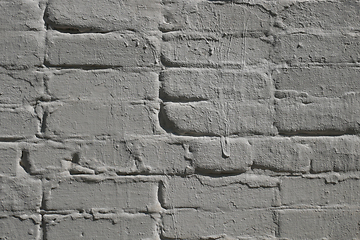 Image showing Detail of old brick exterior many times painted wall, gray color