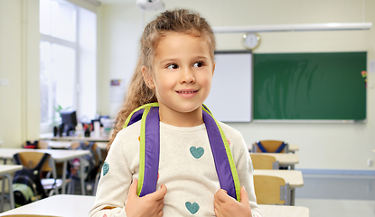 Image showing happy little girl with backpack at school