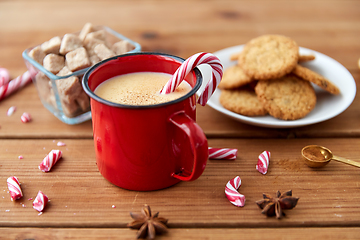 Image showing cup of eggnog with candy cane, cookies and anise