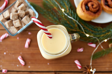 Image showing eggnog with candy cane in mug and cinnamon buns