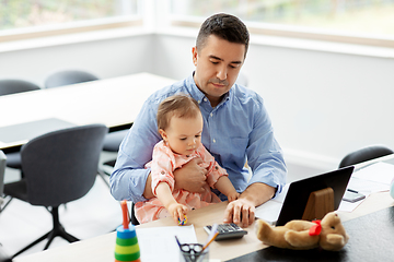 Image showing father with baby working at home