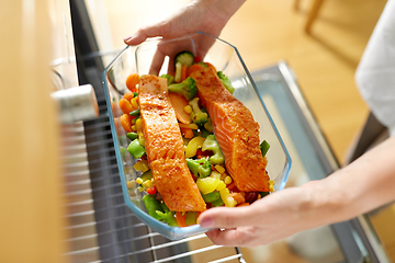 Image showing woman cooking food in oven at home kitchen