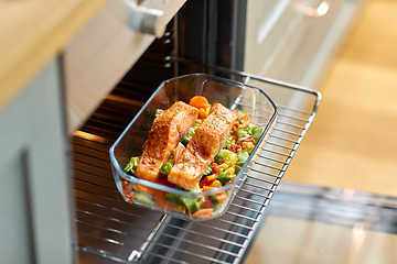 Image showing food cooking in baking dish in oven at home