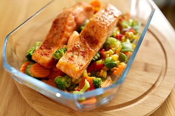 Image showing salmon fish in baking dish on kitchen table