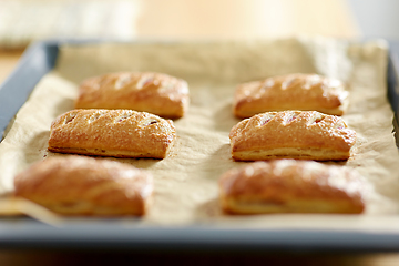 Image showing close up of baking tray with jam pies