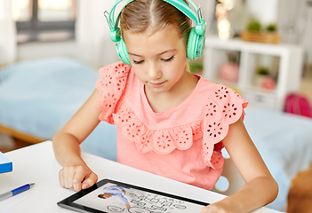 Image showing girl in headphones with tablet computer at home