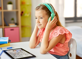 Image showing girl in headphones with tablet computer at home