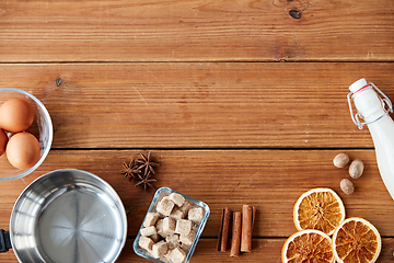 Image showing ingredients for eggnog, sugar and spices on wood