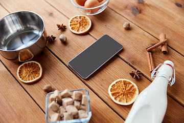 Image showing smartphone, ingredients for eggnog cooking