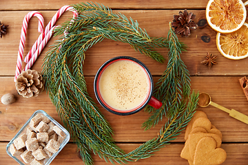 Image showing cup of eggnog, fir branches, gingerbread and sugar